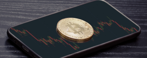 Bitcoin on a phone showing a crashing market